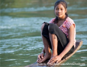 Girl on boat by the river, Som Village, Cambodia (Photo by Anna Willett) unitedworldschools org